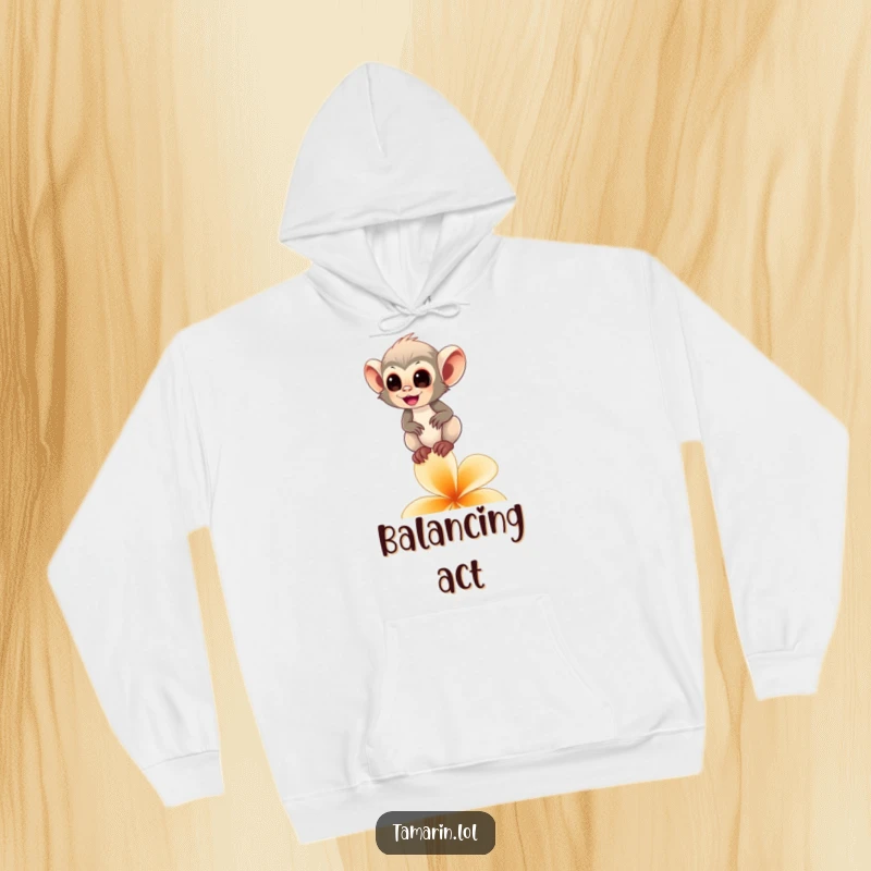 Funny tamarin monkey hoodie depicting a happy primate balancing on a flower petal, offering comfort and a touch of whimsy.