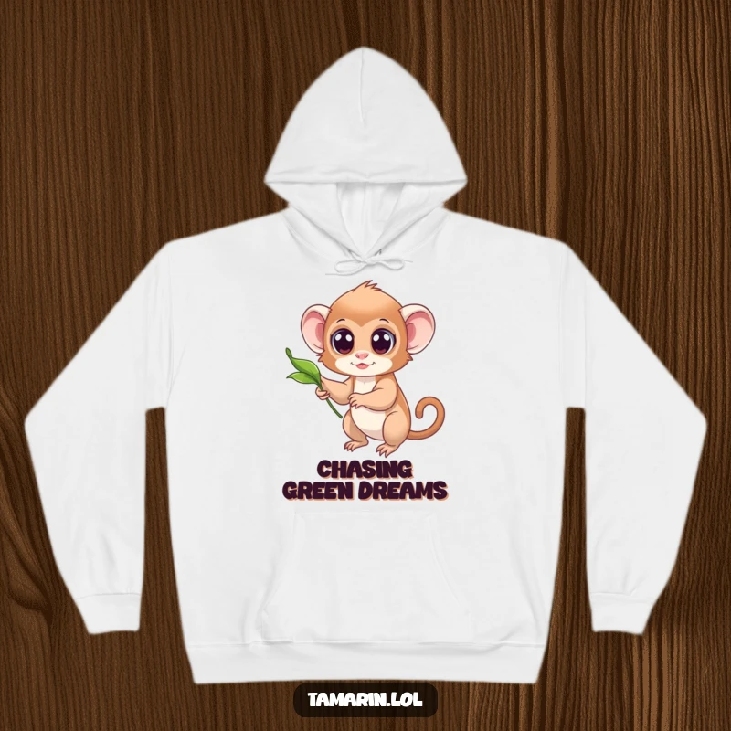 Funny hoodie featuring a tamarin with wide, innocent eyes reaching for a softly drifting leaf.