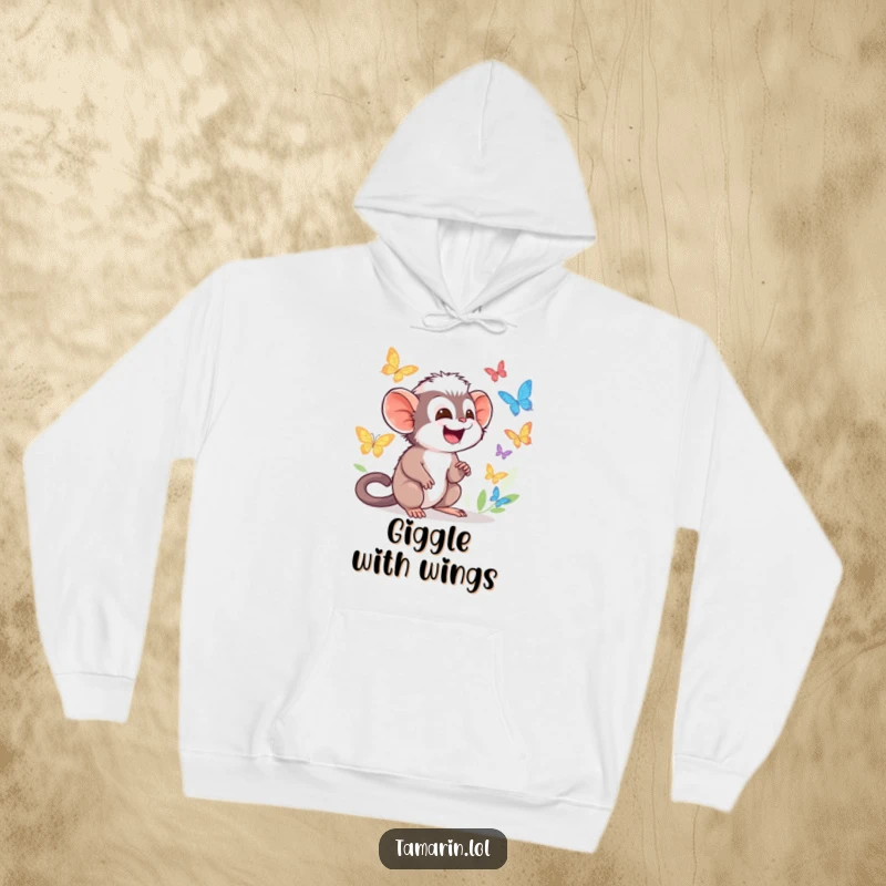 Funny Tamarin Hoodie with character giggling while watching colorful butterflies flutter by, feeling cozy and happy.