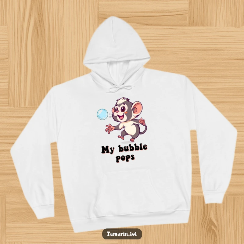 Funny tamarin hoodie depicting a happy monkey in pursuit of a shimmering, ethereal bubble, radiating pure delight.