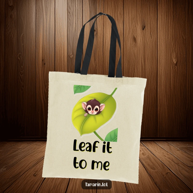 Funny tamarin tote bag with a cute monkey peeking playfully from a large, green leaf, great for shoppers.